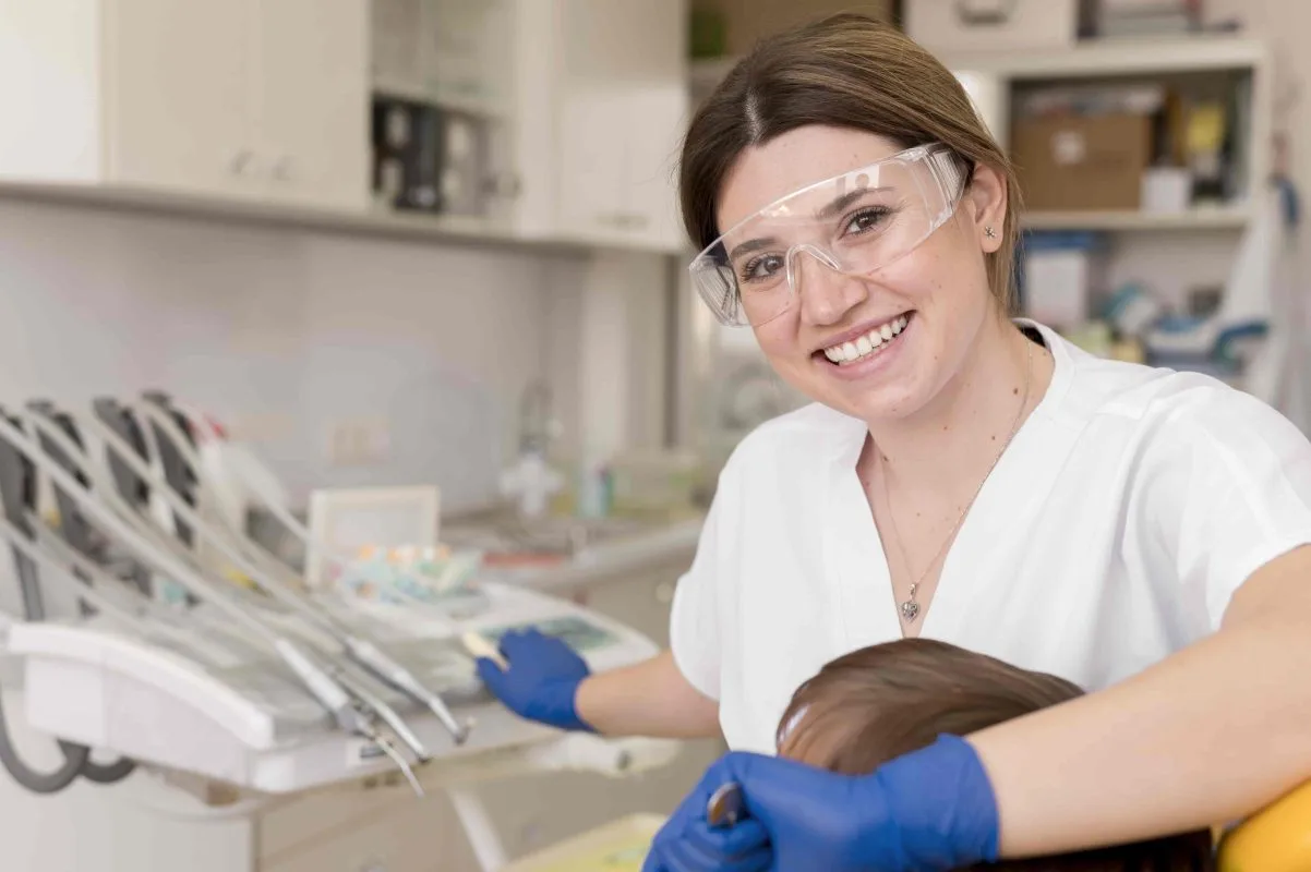 A dental hygienist cleaning a patient’s teeth